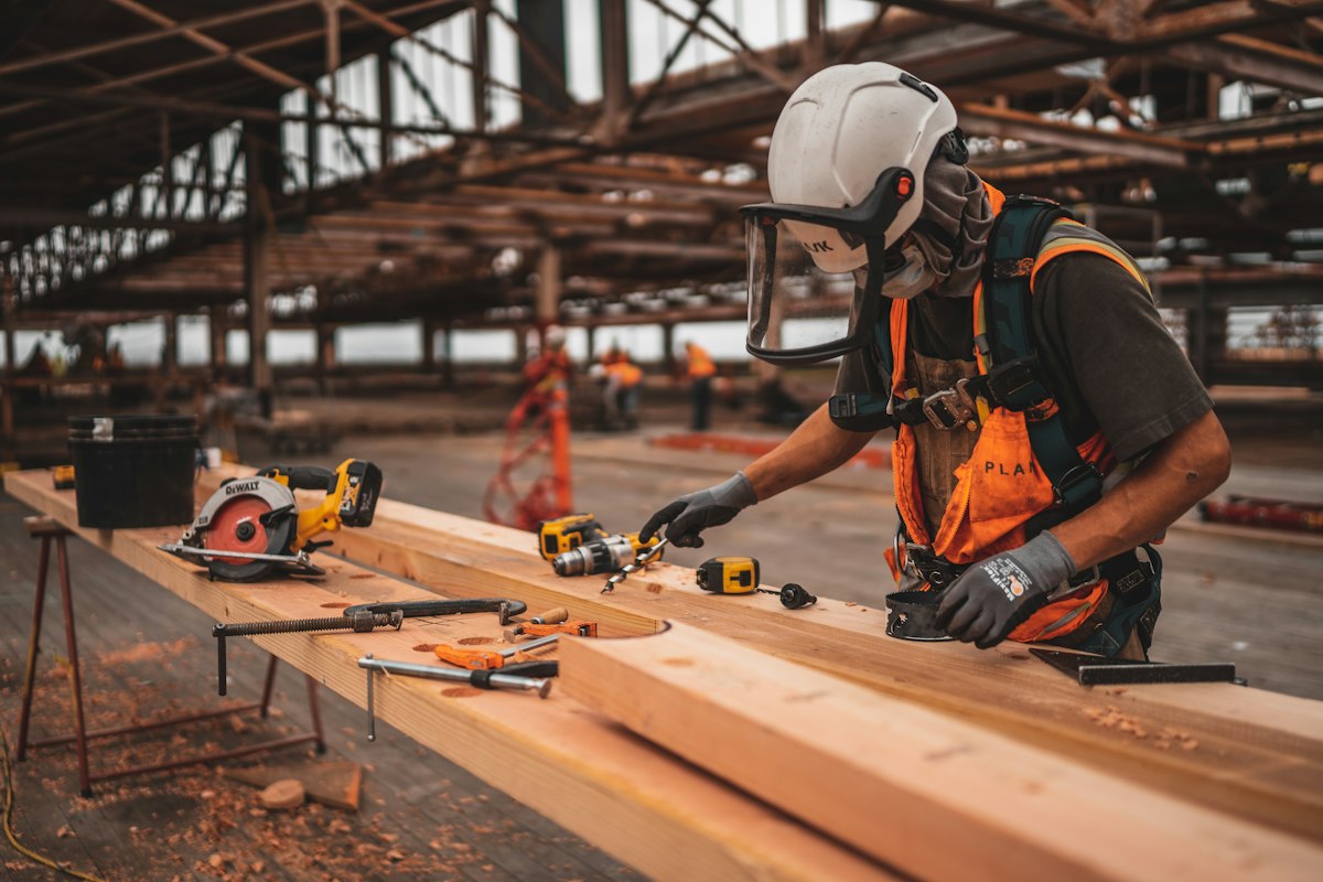 Carpenter measuring a timber during a home build