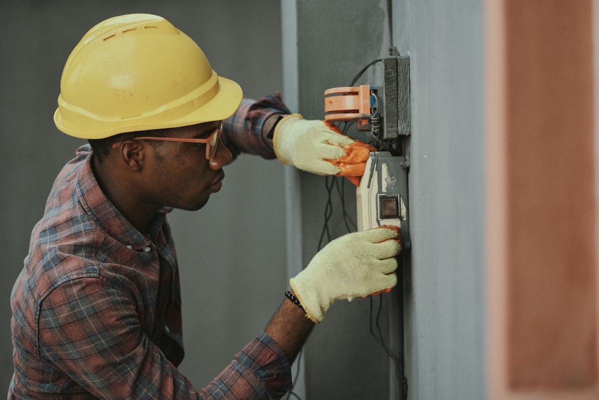 A specialist fitting an electrical panel during a home improvement